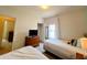 Cozy bedroom featuring twin beds, dresser with TV, closet, and natural light from the window at 5356 Diplomat Ct # 108, Kissimmee, FL 34746