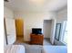 Bedroom showcases twin beds, dresser with TV, and closet space for organized storage solutions at 5356 Diplomat Ct # 108, Kissimmee, FL 34746