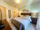 This bedroom features a queen bed, two nightstands, an entertainment center, and an ensuite bathroom at 5356 Diplomat Ct # 108, Kissimmee, FL 34746