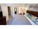 This bedroom features a queen bed, two nightstands, an entertainment center, and access to the bathroom and hallway at 5356 Diplomat Ct # 108, Kissimmee, FL 34746
