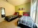 Bedroom with two beds, side table, window, wall mirror and wall art at 5356 Diplomat Ct # 108, Kissimmee, FL 34746