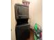 The laundry area features a stacked washer and dryer, plus a small black metal shelving unit at 5356 Diplomat Ct # 108, Kissimmee, FL 34746