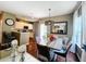 Elegant dining and living area with a stunning dining table and hardwood flooring throughout at 5356 Diplomat Ct # 108, Kissimmee, FL 34746