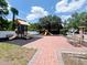 Community playground featuring slides, climbing structures, benches, and a rubberized safety surface at 5356 Diplomat Ct # 108, Kissimmee, FL 34746