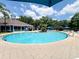 Outdoor community pool area with lounge chairs and splash fountain for relaxing summer days at 5356 Diplomat Ct # 108, Kissimmee, FL 34746