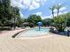 Outdoor pool with lounge chairs and a splash fountain for relaxing summer days at 5356 Diplomat Ct # 108, Kissimmee, FL 34746