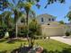 Charming two-story home with a well manicured lawn and beautiful landscaping at 5704 Ansley Way, Mount Dora, FL 32757