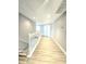Upstairs hallway with modern flooring leading to bedrooms and bathrooms at 5704 Ansley Way, Mount Dora, FL 32757