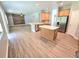 Open kitchen with wood cabinets, stainless steel appliances, and a central island at 5704 Ansley Way, Mount Dora, FL 32757