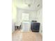 Laundry room with tile flooring, utility sink, shelving and a modern washer and dryer at 5704 Ansley Way, Mount Dora, FL 32757