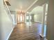 Bright living room with stylish flooring, modern lighting, and a spacious open floor plan at 5704 Ansley Way, Mount Dora, FL 32757