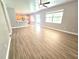 Spacious living room with lots of natural light and modern flooring throughout the home at 5704 Ansley Way, Mount Dora, FL 32757