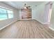 Bright living room features wood-style flooring, a ceiling fan, and a unique wood accent wall at 5704 Ansley Way, Mount Dora, FL 32757