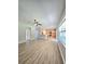 Open concept living room boasts wood-look floors and a view to the kitchen at 5704 Ansley Way, Mount Dora, FL 32757