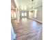 Bright living room with stylish flooring, modern lighting, and a spacious open floor plan at 5704 Ansley Way, Mount Dora, FL 32757