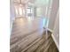 Open concept living space with modern flooring, lots of light, and decorative columns at 5704 Ansley Way, Mount Dora, FL 32757