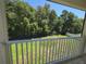 Enjoy a beautiful view of the backyard trees from the home's second-story screened-in porch at 5704 Ansley Way, Mount Dora, FL 32757