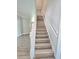 Beautiful wood staircase with white risers and banister and modern flooring at 5704 Ansley Way, Mount Dora, FL 32757