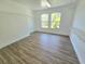 A spacious walk-in closet is well-lit with hardwood floors and includes shelving for plenty of storage at 5704 Ansley Way, Mount Dora, FL 32757