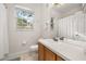 Bright bathroom features a large mirror, a window, and a vanity with a sink at 6214 Stevenson Dr # 106, Orlando, FL 32835
