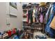 Organized walk-in closet with shelves and rods filled with clothes, shoes, and accessories at 6214 Stevenson Dr # 106, Orlando, FL 32835