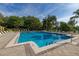 Community pool surrounded by lounge chairs and lush landscaping on a sunny day at 6214 Stevenson Dr # 106, Orlando, FL 32835