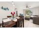 Open concept dining area with table, with view to living room and outdoor scenery beyond sliding glass door at 6214 Stevenson Dr # 106, Orlando, FL 32835