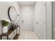 Bright entryway featuring tiled floors, a console table with decor, and a front door with a closet at 6214 Stevenson Dr # 106, Orlando, FL 32835