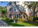 Multi-story condo building showing screened in patio area and manicured landscaping around the base at 6214 Stevenson Dr # 106, Orlando, FL 32835