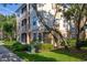 Multi-story condo building showing screened in patio area and manicured landscaping around the base at 6214 Stevenson Dr # 106, Orlando, FL 32835