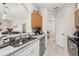 Efficient kitchen with stainless steel appliances, double sink, and an open design with sightlines to the dining area at 6214 Stevenson Dr # 106, Orlando, FL 32835