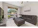 Spacious living room with tile floors, a large gray sectional, TV, and a sliding glass door at 6214 Stevenson Dr # 106, Orlando, FL 32835