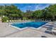 Sparkling community pool surrounded by well-maintained landscaping and ample seating at 6214 Stevenson Dr # 106, Orlando, FL 32835