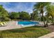 Relaxing community pool with comfortable lounge chairs and lush landscaping surrounding the area at 6214 Stevenson Dr # 106, Orlando, FL 32835