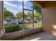 A cozy screened patio area with tile floors and a view of the parking and green landscape at 6214 Stevenson Dr # 106, Orlando, FL 32835