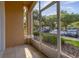 Screened patio featuring a tile floor and view of parking area with green landscaping at 6214 Stevenson Dr # 106, Orlando, FL 32835