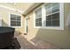 Enclosed patio featuring a built-in grill and a paved floor at 7144 Five Oaks Dr, Harmony, FL 34773