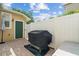 Enclosed patio featuring a built-in grill and a white fence at 7144 Five Oaks Dr, Harmony, FL 34773