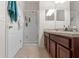 Bathroom featuring a vanity with double sinks, a walk-in shower, and tile flooring at 7144 Five Oaks Dr, Harmony, FL 34773