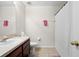 Neutral bathroom featuring a vanity with a stone countertop and a shower with a white patterned curtain at 7144 Five Oaks Dr, Harmony, FL 34773