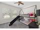 bedroom with a unique bunk bed with a slide, carpet, and bright windows at 7144 Five Oaks Dr, Harmony, FL 34773