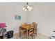 Inviting dining area features ceramic tile flooring, natural light, and a modern lighting fixture at 7144 Five Oaks Dr, Harmony, FL 34773
