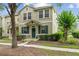 Charming two-story townhome featuring a well-maintained lawn and inviting green door at 7144 Five Oaks Dr, Harmony, FL 34773