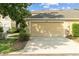 Exterior featuring a two car garage and paved driveway at 7144 Five Oaks Dr, Harmony, FL 34773