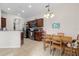 Spacious kitchen and dining area features stainless steel appliances and an open floor plan at 7144 Five Oaks Dr, Harmony, FL 34773
