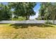 Large, well-maintained backyard enclosed by a white fence and surrounded by mature trees at 7222 Stanford Dr, Lakeland, FL 33809