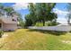 Spacious backyard with lush green grass, bordered by a white privacy fence and mature trees at 7222 Stanford Dr, Lakeland, FL 33809