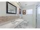 Well-lit bathroom features a large mirror, single sink vanity, and a walk-in shower at 7222 Stanford Dr, Lakeland, FL 33809