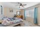 Well-lit bedroom with neutral colors, ceiling fan and a window with view at 7222 Stanford Dr, Lakeland, FL 33809