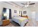 Bright bedroom with wood floors, decorative tray ceilings, and neutral decor create a relaxing atmosphere at 7222 Stanford Dr, Lakeland, FL 33809